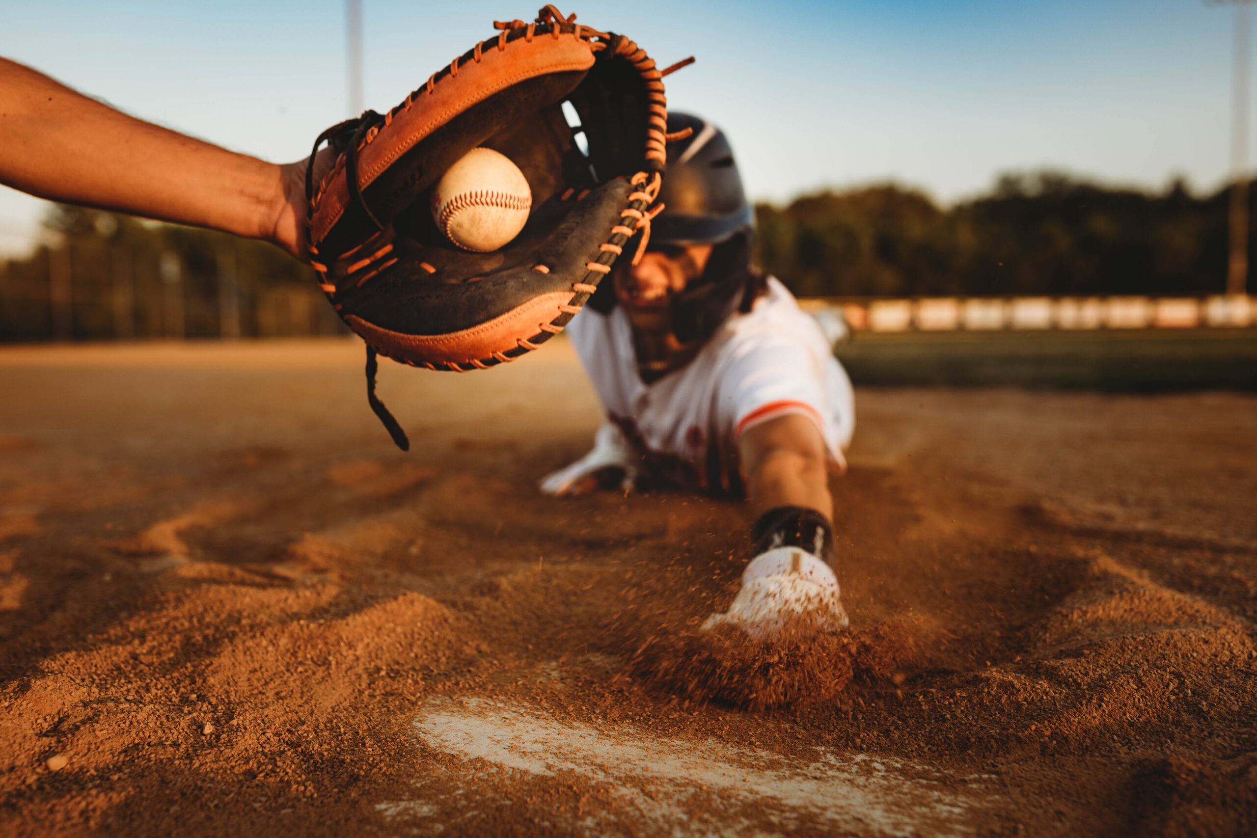 baseball player sliding into home plate