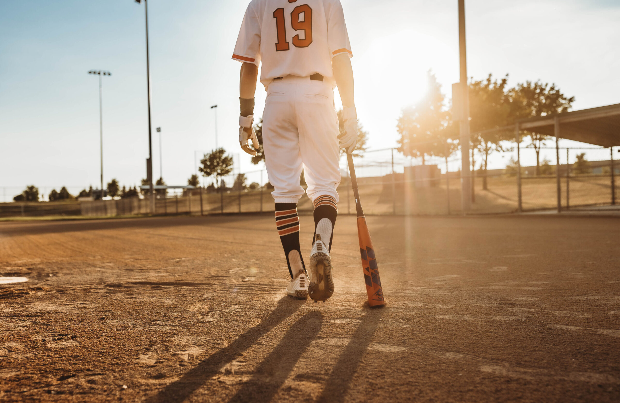 Baseball player walking up to bat