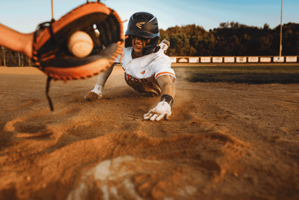 high school senior sliding into home base. 